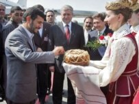 Ahmadinejad received a traditional welcome with bread and salf on his arrival May 21 (AFP)