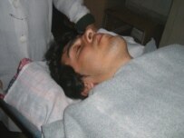 Agil Khalil in a hospital after being attacked (RFE/RL)