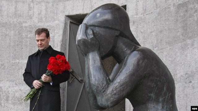 President Dmitry Medvedev lays flowers at a monument honoring victims of Stalin purges