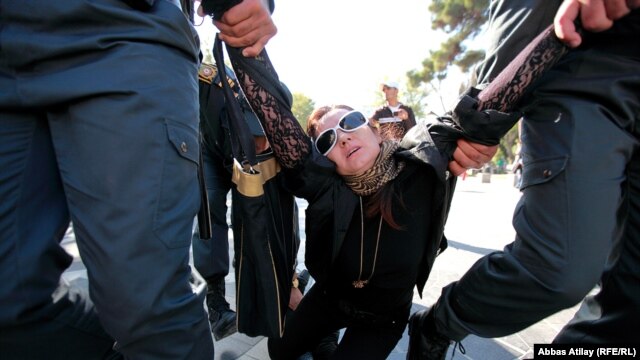Security forces apprehend an opposition protester in Baku.