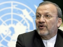 Switzerland -- Iranian Foreign Minister Manuchehr Mottaki answers journalist's questions during a press conference after his speech at the 4th UN Human Rights Council at the European headquarters of the UN in Geneva, 13Mar2007