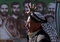 A man in Hebron walks past a Hamas election poster during the Palestinian Authorities legislative elections in January (epa)