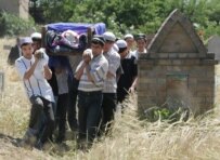 The body of one of the victims of the government crackdown in Andijon being buried in May 2005 (epa)