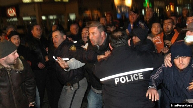 Opposition supporters clash with riot police in Tbilisi on April 23.