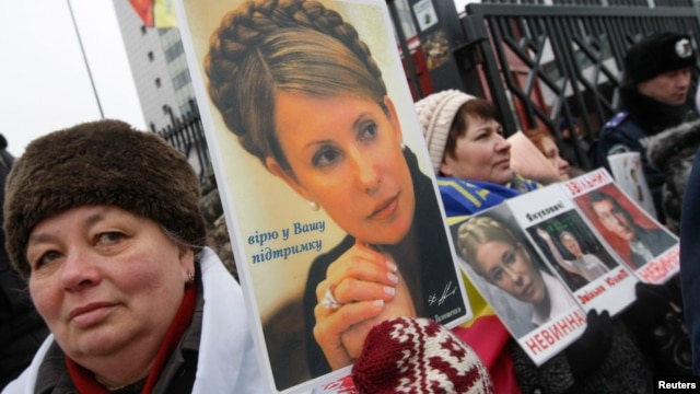Supporters of jailed opposition leader and former Prime Minister Yulia Tymoshenko hold portraits of her during a rally in front of the appeals court building in Kyiv on February 15.