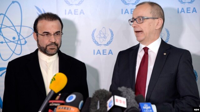 Iranian Ambassador to the IAEA Reza Najafi (left) and Tero Varjoranta, IAEA deputy director general and head of the Department of Safeguards, talk to journalists prior to a meeting in Vienna on December 11.