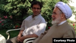 Mehdi Karrubi (right) visits with his son, Mohammad Hossein Karrubi in Tehran on June 4.