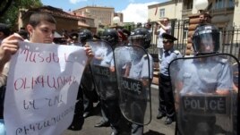 Armenia - A protester outside the presidential palace in Yerevan holds a poster demanding "punishment" for businessman Ruben Hayrapetitian and his bodyguards, 1Jul2012.