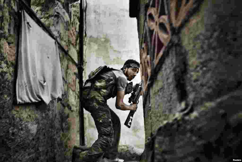 Fabio Bucciarelli of Italy, a photographer working for the Agence France-Presse, won second prize in the Spot News Stories category with the series "Battle to Death." The picture shows a Free Syrian Army fighter taking up a position during clashes with government forces in the Sulemain Halabi district in Aleppo.