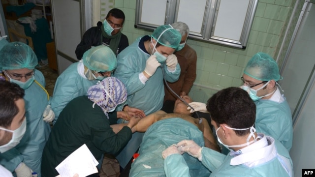 Medics attend to a man at a hospital in Aleppo Province in March after Syria's government accused rebel forces of using chemical weapons.
