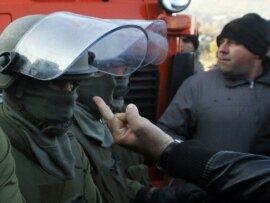 A barricade protester gestures at KFOR soldiers in Jagnjenica on October 20.