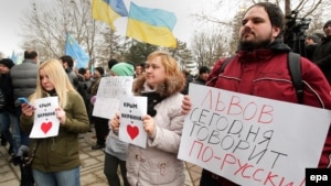 Demonstrators hold banners reading "Lviv speaks Russian language today!" at a rally near the parliament building in Simferopol, Crimea, on February 26.