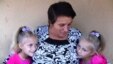 Maria Barbanou (center) is raising two of her granddaughters while their mother, Maria’s daughter, is working in Italy. 