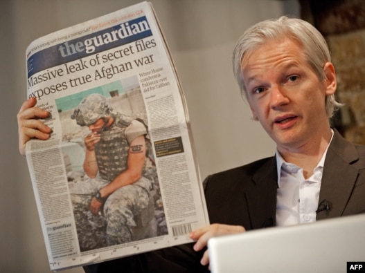 The Australian founder of the whistle-blowing website Wikileaks, Julian Assange, holds up a copy of 'The Guardian' at a press conference in London on July 26.