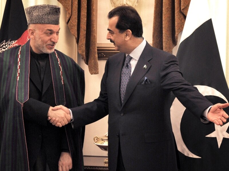 Pakistani Prime Minister Yousuf Raza Gilani (right) meets with Afghan President Hamid Karzai in Islamabad.