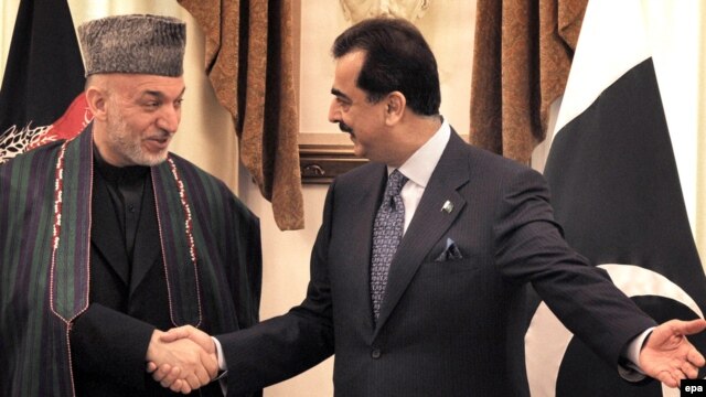 Pakistani Prime Minister Yousuf Raza Gilani (right) meets with Afghan President Hamid Karzai in Islamabad.
