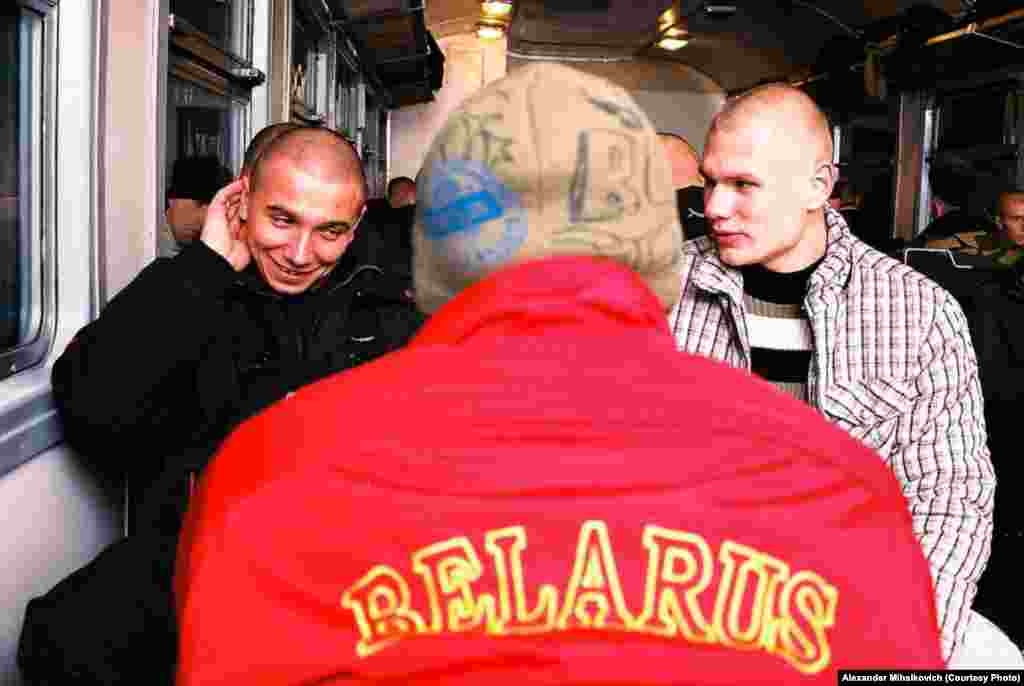 Conscripts chat as they ride on a train before starting their service, which will last 12 to 18 months.