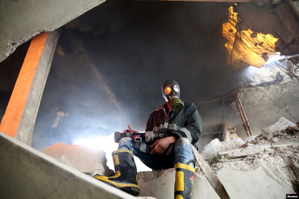 A civil-defense member sits near a site hit by an air strike in the rebel-held Douma neighborhood of Damascus, Syria. (Reuters/Bassam Khabieh)
