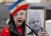A Russian supporter of the late Yugoslav President Slobodan Milosevic holds his portrait at a protest outside the U.S. Embassy in Moscow on March 13. (epa)