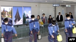 Health officials disinfect the passenger terminal at Incheon International Airport in Seoul.