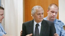 Milutinovic entering the Hague courtroom before the trial began