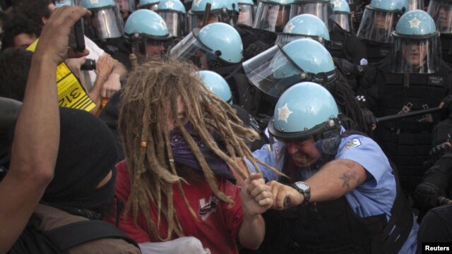 Policemen in riot gear clash with protesters outside the site of the NATO summit in Chicago on May 20. Scores of demonstrators were arrested.