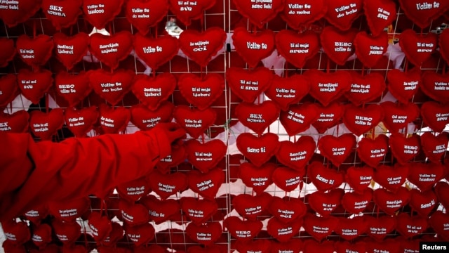 A vendor in the central Bosnian town of Zenica sells heart-shaped cushions with proclamations of love for 1 euro each.