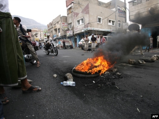 Antiregime activists block a main road in the Yemeni flashpoint city of Taiz.
