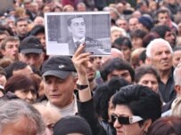 Protesters hold a picture of former Defense Minister Irakli Okruashvili (ITAR-TASS)