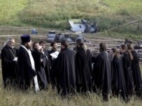 Ukrainian priests praying on August 23 at the site of the crash, near the city of Donetsk (epa)