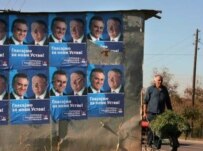 An ethnic Serb in Gracanica, Kosovo, passing posters urging Serbs to vote in the October 28-29 referendum (epa)