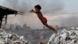 Bangladesh -- A child jumps on the waste products that are used to make poultry feed as she plays in a tannery at Hazaribagh in Dhaka, 09Oct2012