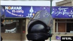 Iranian riot policemen stand guard outside Noavar private University in Tehran during protests by supporters of presidential candidate Mir Hossein Musavi, Tehran on June 14.
