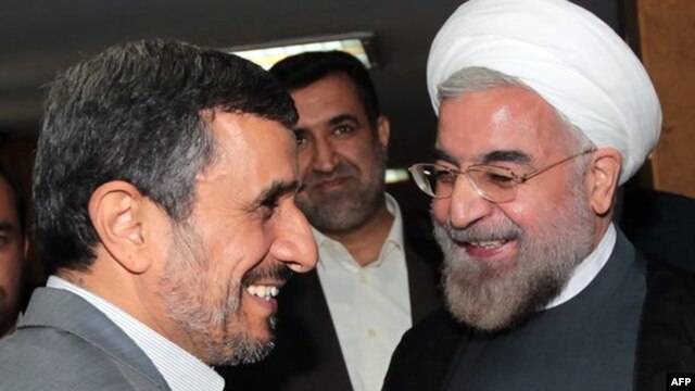 Then-President Mahmud Ahmadinejad (left), who consistently cast doubt on whether the Holocaust ever took place, greets President-elect Hassan Rohani in Tehran in mid-June.