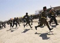 Soldiers take up positions after shots fired at military parade in Kabul (AFP)