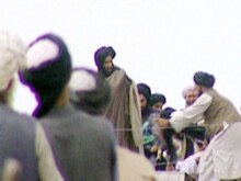 Afghanistan - (FILES) TV grab taken secretly by BBC Newsnight shows Taliban's one-eyed spiritual leader Mullah Mohammed Omar (C) during a rally of his troops in Kandahar before their victorious assault on Kabul in 1996.