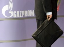 Germany -- A visitor to the Hanover Messe 2006 fair at the stand of Russian gas provider Gazprom in Hanover, 24 Apr. 2006
