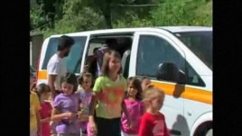 Schoolchildren from Liplje, Bosnia climb out of a minivan donated by a Dutch NGO to help them get to school. Screen shot from RFE/RL's "TV Liberty" program, 24Jul2012.