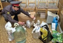 A police officer inspects a haul of bootleg vodka confiscated in Belgorod Oblast last month (ITAR-TASS)