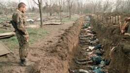 This photo -- showing a Russian soldiers inspecting bodies of civilians in a mass grave in Chechnya in 1995 -- was used by Russia's state-owned Channel One television to highlight recent Ukrainian suffering.