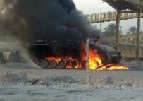 A U.S. military vehicle after being stuck by an explosive device in Baghdad in November 2005 (RFE/RL)
