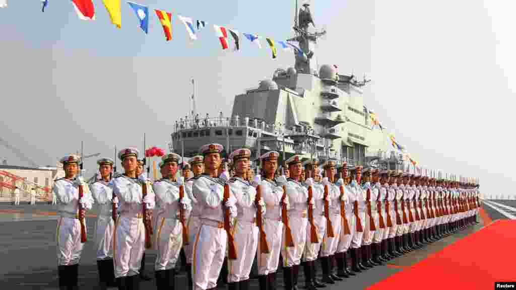Chinese naval honor guards stand as they wait for an inspection on the "Liaoning" aircraft carrier in Dalian, Liaoning Province on September 25. (REUTERS/Xinhua/Zha)