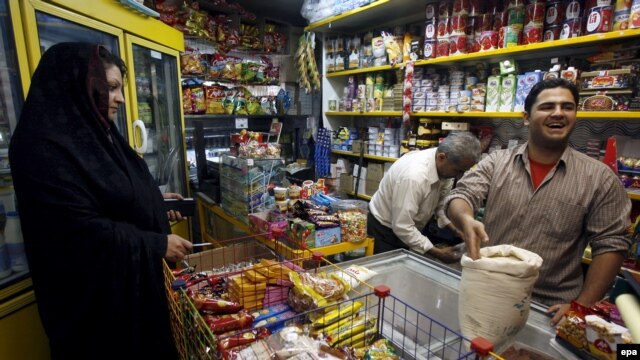 An Iranian woman complains to a merchant about the rising rice prices in Tehran,