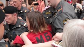 Police arrest activists at the rally in Moscow