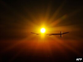Switzerland -- Experimental aircraft 'Solar Impulse' with pilot Andre Borschberg onboard flies at sunrise above Payerne's Swiss airbase on 08Jul2010