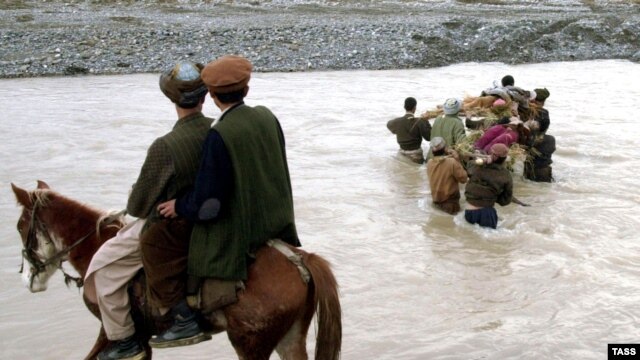 High-stakes business: the bodies of five drug smugglers, shot in a clash with guards on the Tajik border, are returned to Afghanistan.