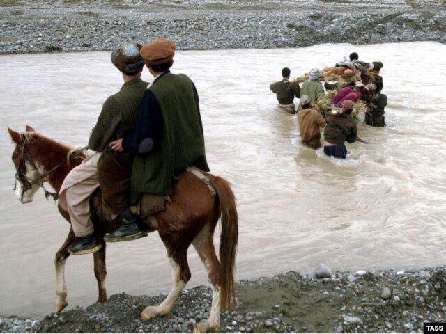 Bloody history: The bodies of five drug smugglers are returned to Afghanistan after a clash between Russian soldiers guarding Tajikistans border with Afghanistan in 2004.