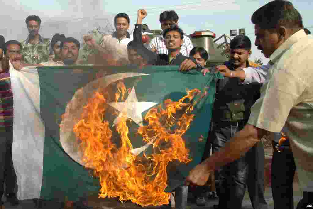Indian activists shout slogans as they burn a Pakistani flag during a demonstration against Pakistan's imprisonment of Sarabjit Singh, an Indian prisoner held in the country. (AFP/Narinder Nanu)