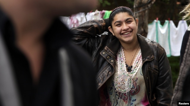 Leonarda Dibrani, 15, smiles as she walks in the town of Mitrovica on October 17, following her deportation from France.