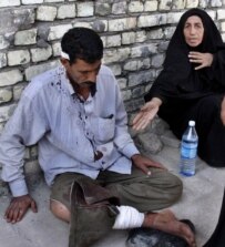 An injured man rests outside of a hospital after being hurt in an explosion in Baghdad, October 25 (epa)